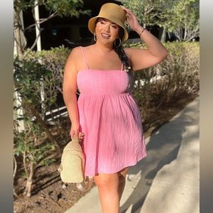 Pink spaghetti strap mini dress with a textured pattern and slightly open back